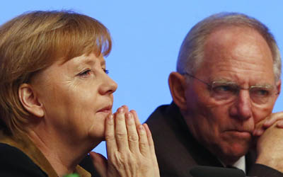 German Chancellor and leader of CDU Merkel talks to party fellow and Finance Minister Schaeuble during the CDU's annual party meeting in Hanover
