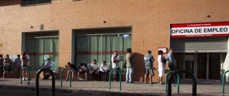 People queue to enter a government-run employment office in Madrid