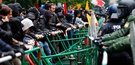 Riot police try to prevent protestors from breaking through barricades near the ECB headquarters during a "Blockupy" demonstration in Frankfurt