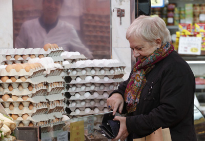 A woman shops at a market in Barcelona